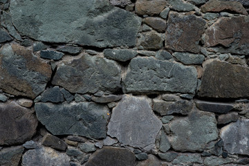 Texture of stone wall made of grey stones