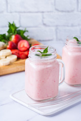 Pink smoothie with banana and strawberry for healthy, vegan diet