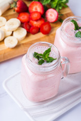 Pink smoothie with banana and strawberry for healthy, vegan diet