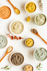 Blue, yellow, white. red, black cosmetic clay background on white table top-down pattern