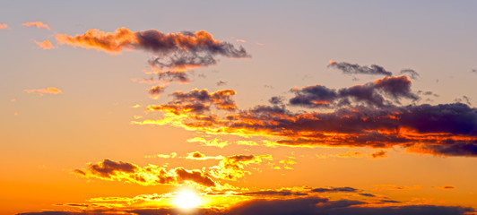 mellow sunset sky landscape background natural color of evening cloudscape panorama with setting sun behind clouds wide panoramic view