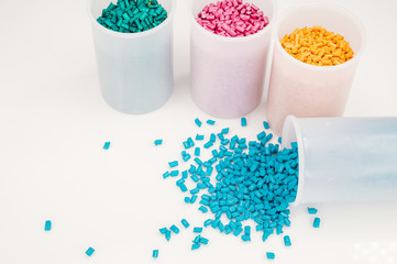 Obraz na płótnie Canvas Plastic granules close up for holding,Colorful plastic granules with white background. and dollar money,Plastic Business,Plastic industry.