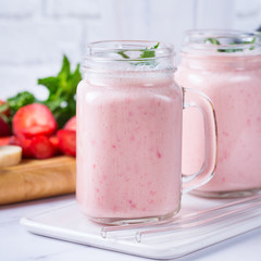 Pink smoothie with banana and strawberry for healthy, vegan diet