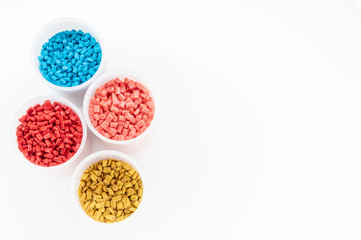 Plastic granules close up for holding,Colorful plastic granules with white background. and dollar money,Plastic Business,Plastic industry.