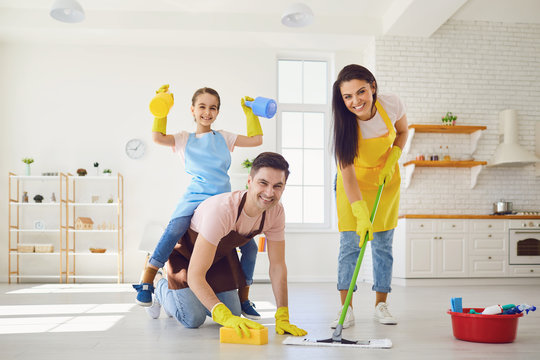 Happy family cleans the room in the house.