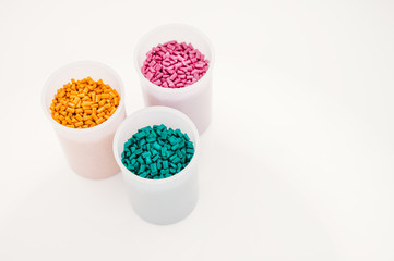 Obraz na płótnie Canvas Plastic granules close up for holding,Colorful plastic granules with white background. and dollar money,Plastic Business,Plastic industry.