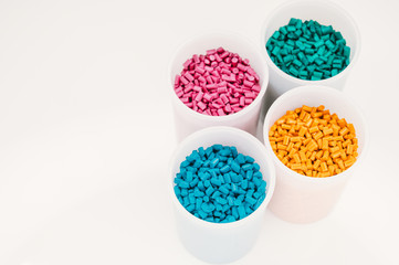 Plastic granules close up for holding,Colorful plastic granules with white background. and dollar money,Plastic Business,Plastic industry.