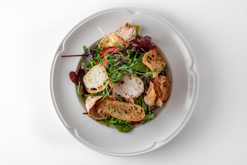 Salad of ham, prosciutto, pork or beef with vegetables, greens, berries and sauce. Nutritious, healthy dish. Banquet festive dishes. Gourmet restaurant menu. White background.