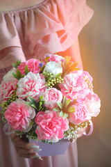 Bouquet of peonies on woman hands. . Mothers day, Womens day, Valentines day, birthday or wedding greeting card. Sun light effect.