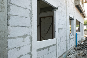 lightweight cement brick and white lintel plaster to joint for reinforce widow house frame in construction site.