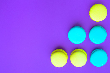 multicolored cookies on a purple background with copy space, template