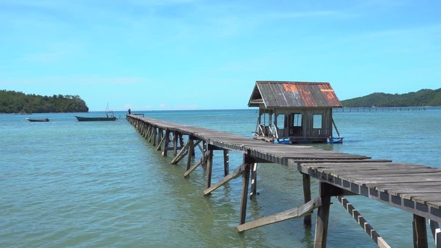 Point of view footage of wooden jetty at water village