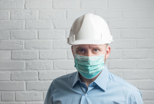 Engeener In Helmet Wearing Medical Mask For Protect Virus On White Background