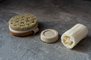 Loofah, solid shampoo, brush body sponge for zero waste washing or bath on grey background
