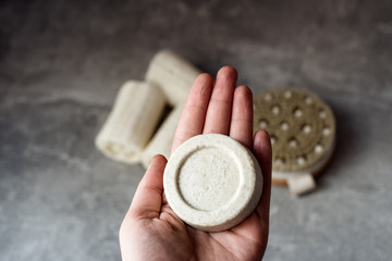 Eco friendly natural solid shampoo on grey background. Concept animal fat free, zero waste, plastic...
