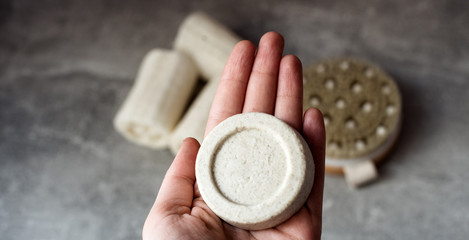 Eco friendly natural solid shampoo on grey background. Concept animal fat free, zero waste, plastic free product