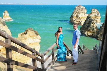 Happy Young couple during vacation at the Algarve coast Portugal visiting Praia do Camilo beach near Lagos