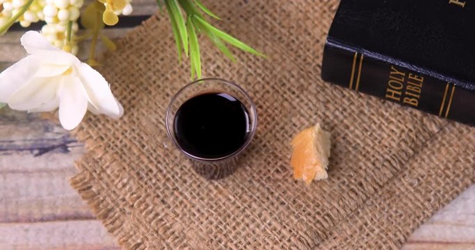 Taking communion concept - the wine and the bread symbols of Jesus Christ blood and body with Holy Bible. Easter Passover and Lord Supper concept. Dolly shot 4k