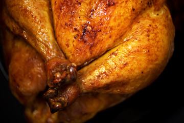 Whole roasted chicken in baking dish. Top view. Copy space. Macro shoot.