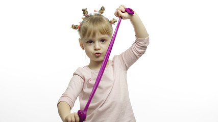 Kid playing with hand made toy slime. Child having fun making purple slime