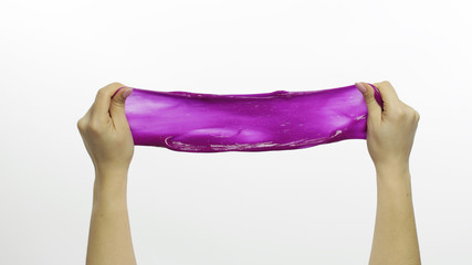 Woman hands playing oddly satisfying purple slime. White background. Antistress