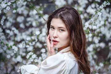young asian woman in a flowering garden