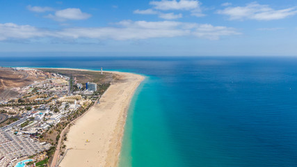 Fototapeta na wymiar Morro Jable Canary Island, Fuerteventura Spain, Aerial view on coast of atlantic ocean and beach, Drone shot of sea 