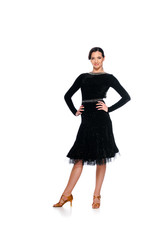 smiling elegant young ballroom dancer in black dress with hands on hips isolated on white