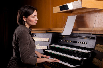 Organist playing a pipe organ, closeup view