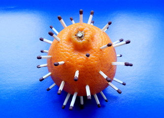 2019 Coronavirus-nCov. A clear 3d model of the virus made of tangerine and matches on a blue...