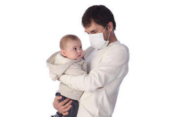 Caucasian ather is holding and looking to his baby boy and they wear a mask. Corona virus or covid-19 viral disease outbreak effect to people lifestyle and healthcare concept..