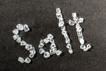 The inscription salt is composed of crystals of coarse sea salt.