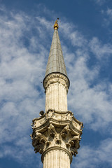 The minaret of Dolmabahce Mosque in the Istanbul on blue sky.Close up taken of Ottoman...