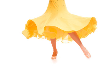 Fototapeta premium cropped view of elegant young ballroom dancer in yellow dress dancing isolated on white