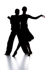 Fototapeta na wymiar silhouettes of elegant couple of ballroom dancers dancing on white