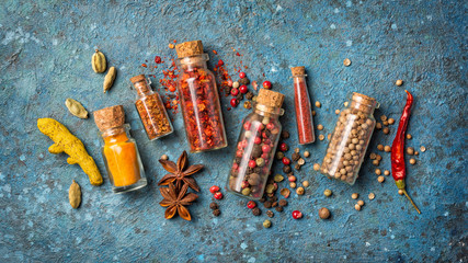 Different spices in glass vials for tasty meals