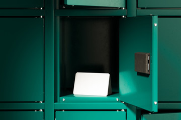 Green Safe Deposit Boxes With One Opened Locker And Blank Folded Paper. 3d rendering.