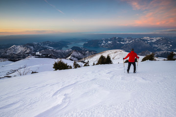 Fototapeta na wymiar A man enjoys a winter trekking adventure in Lombardia, Italy.