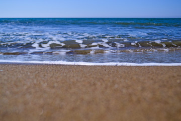 waves with foam on tropical sandy beach. copy space