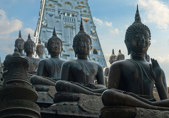 Buddha sitting statues in Colombo, Sri Lanka, Gangaramaya Buddhist temple architecture.