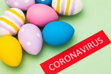 Fototapeta na wymiar A tag with an inscription and Easter eggs, a major plan. The concept of banning festive events in connection with the coronavirus outbreak COVID-19