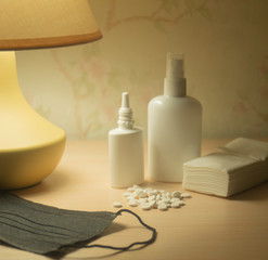 Obraz na płótnie Canvas lamp and pills mask and spray stay at home