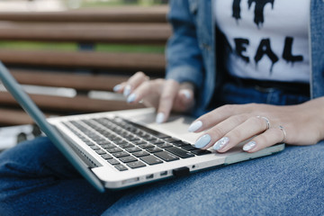 Woman hands typing on laptop keyboard