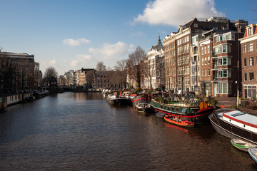 Fototapeta premium old house in Amsterdam city center with canals and boats