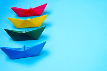 Bright colored origami paper boats.