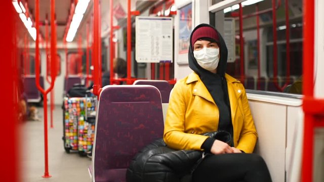 Volunteer in a medical mask in the subway. Quarantine coronavirus infection COVID-19. State of emergency. The prohibition of free movement in the city. 