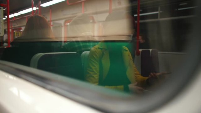 Reflection of a woman in a medical mask in a subway train. The coronavirus epidemic in Europe. State of emergency. The territory is quarantined coronavirus infection COVID-19.