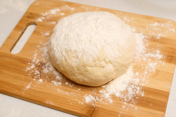 dough ball on the Board on the kitchen table