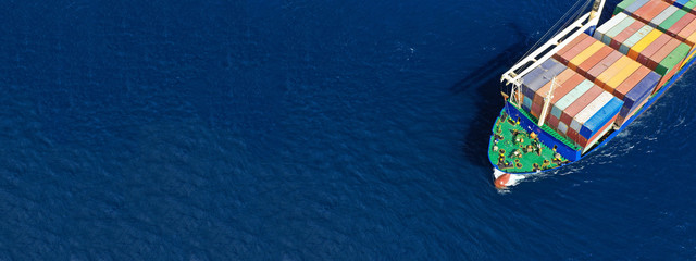Fototapeta na wymiar Aerial drone top down photo of fully loaded large truck size container tanker ship cruising the Mediterranean deep blue sea
