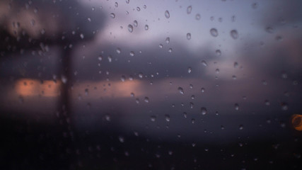Fototapeta na wymiar Rain Drops on window at Dusk